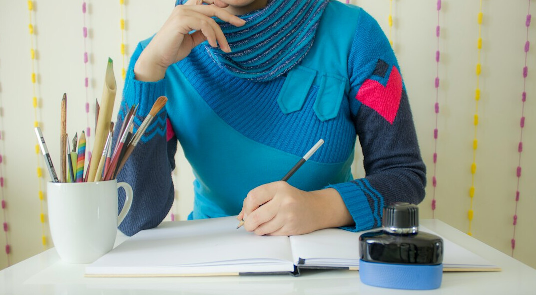writer at desk with notebook