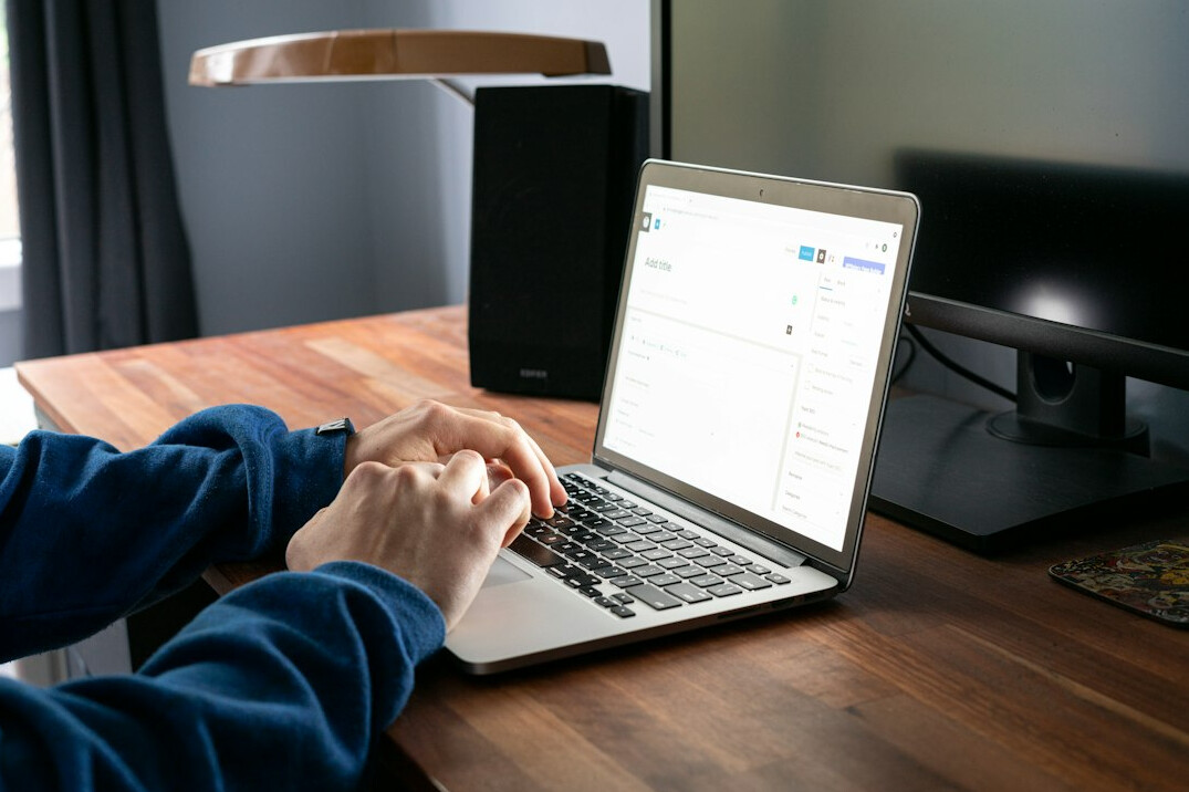 author typing on laptop