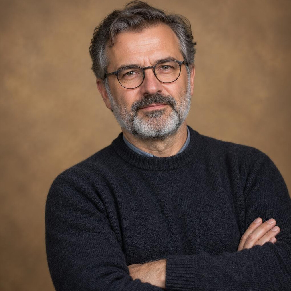 Studio portrait of a middle-aged Croatian male writer with glasses and a grey beard